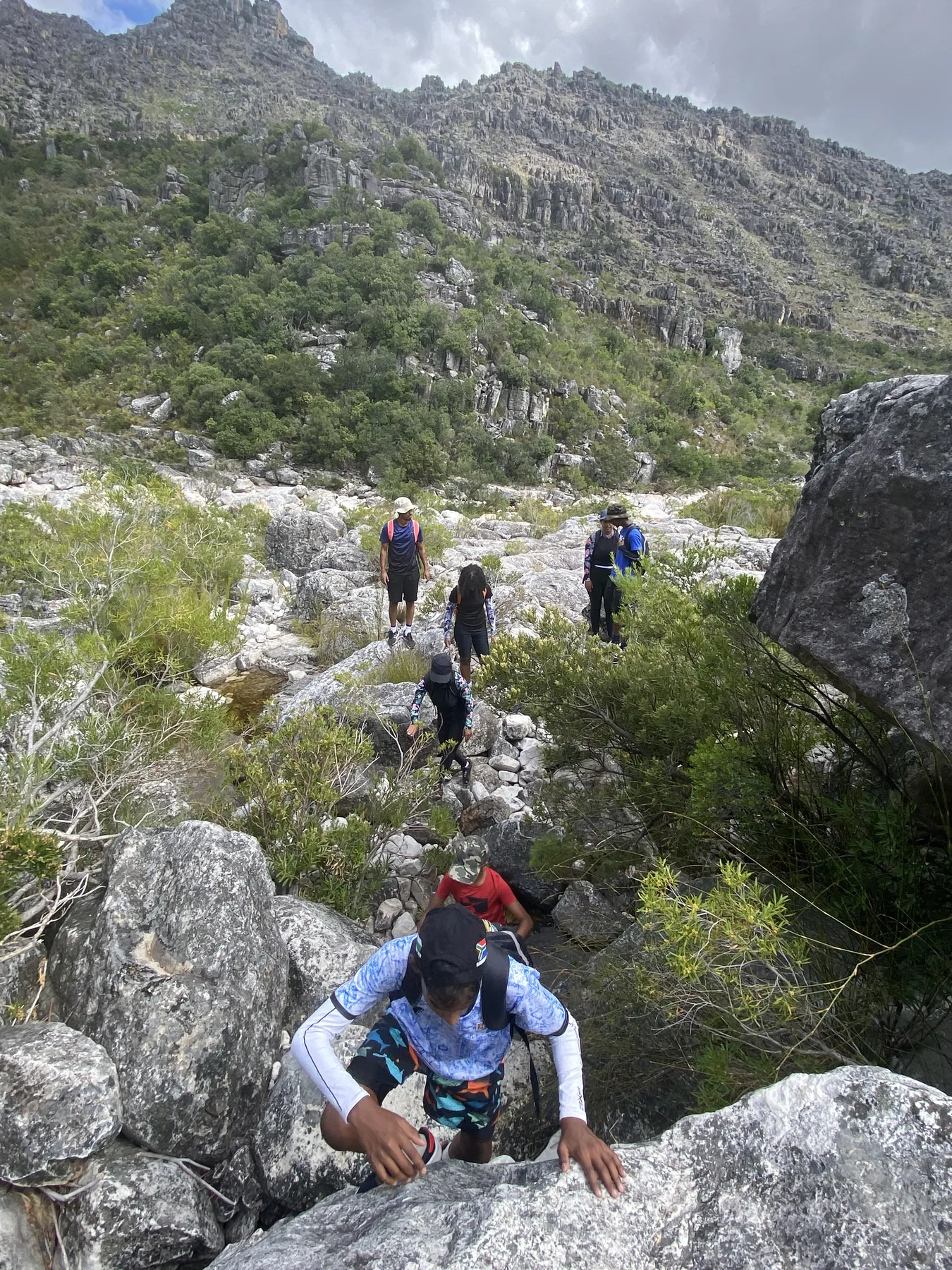 Guests rock hopping through the Bainskloof ravine