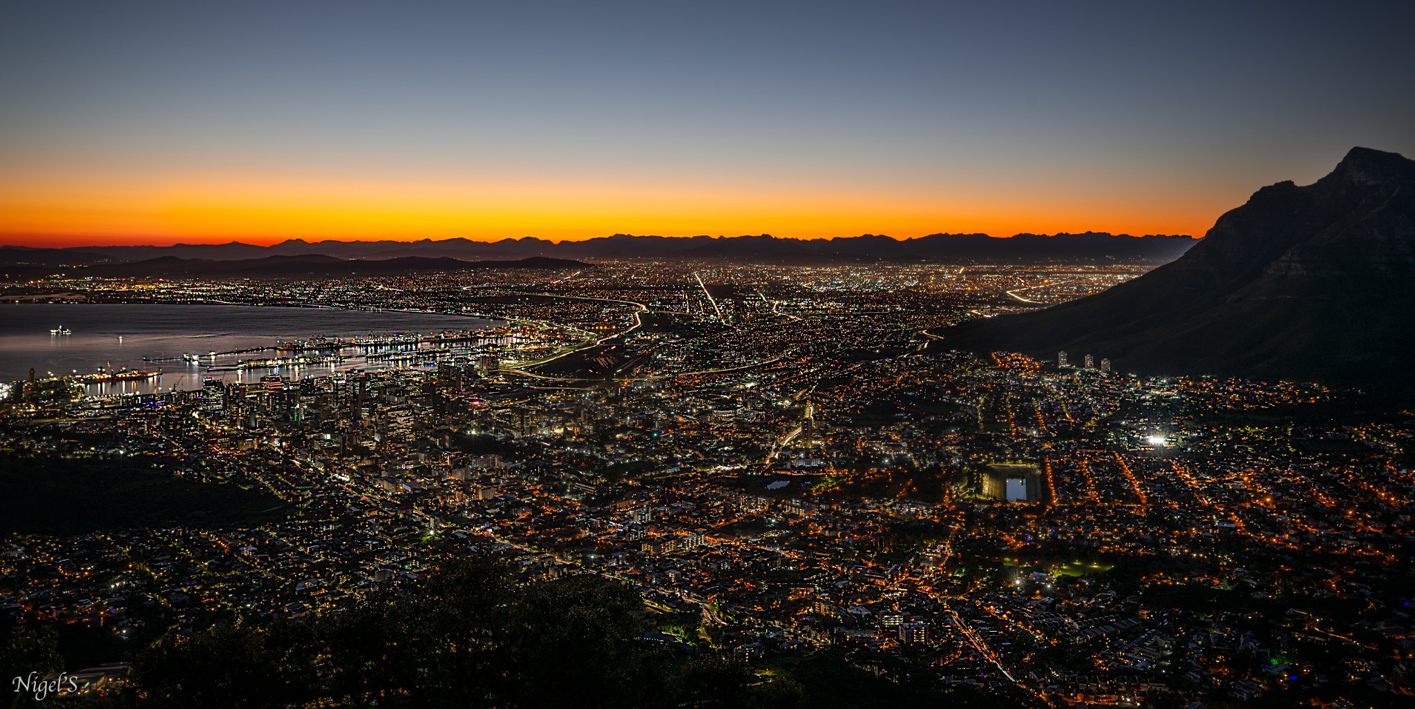 Panoramic view of Cape Town city lights from Lion's Head around twilight