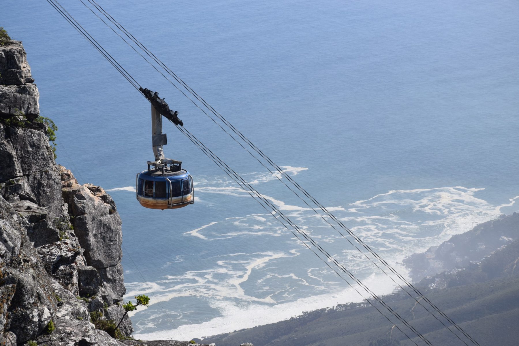 Table Mountain cable car travelling above the Atlantic Ocean