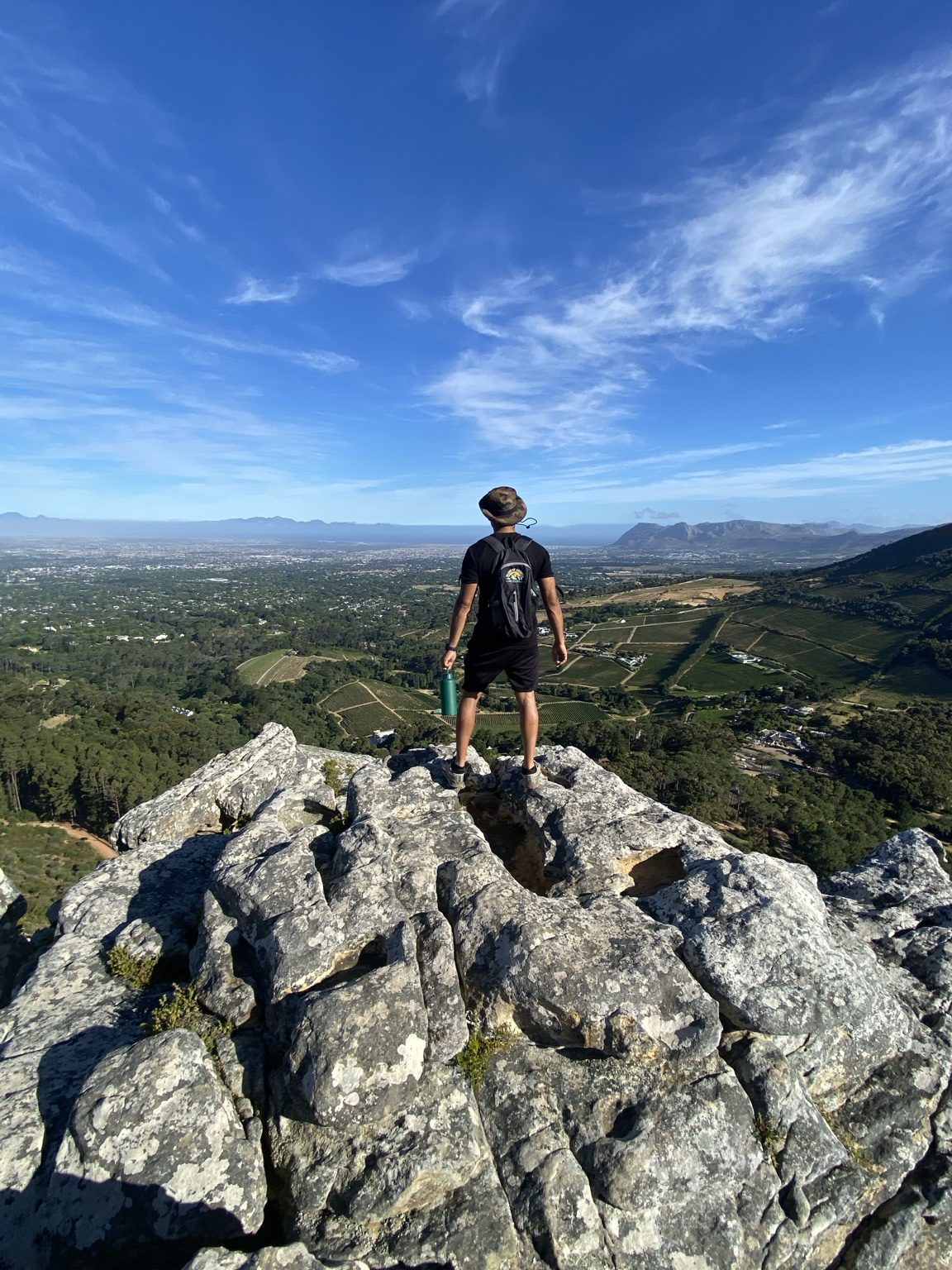 Hiker looking across a wide landscape from Table Mountain