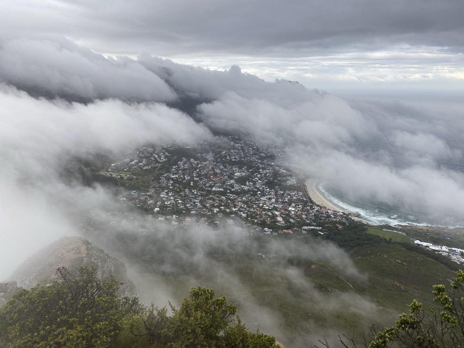 Cloud spilling over Table Mountain toward Camps Bay